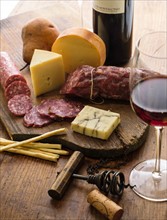 Assorted cheeses with salami and red wine