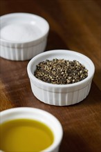 Ramekins with salt, pepper and olive oil