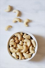 Bowl of cashews on white background
