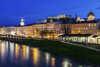 Austria, Salzburg, Illuminated townhouses in riverbank