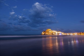 Spain, Valencian Community, Peniscola, Illuminated town by sea