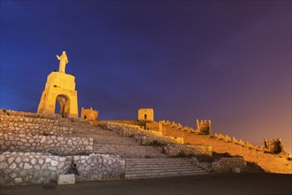 Spain, Andalusia, Almeria, Statue of Sacred Heart of Jesus at dusk