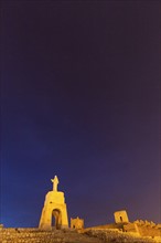 Spain, Andalusia, Almeria, Statue of Sacred Heart of Jesus at dusk