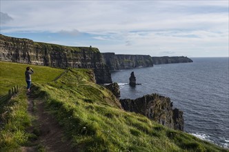 Ireland, Clare County, Woman looking at view on Cliffs of Moher