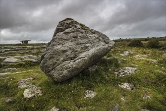 Ireland, Clare County, Burren, Big stone with Poulnabrone Dolmen in background