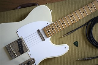 Fender Telecaster and music equipment lying on guitar case