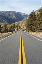 USA, California, Eastern Sierras, Route 88, Empty road with mountain in background