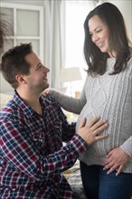 Pregnant woman and partner looking at each other