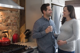 Mid adult couple standing in kitchen