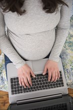 High angle view of pregnant woman using laptop