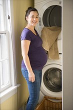 Pregnant woman doing laundry