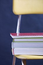 Close up of books stacked on chair