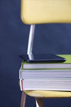 Close up of tablet and books on chair