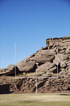 USA, Arizona, American football field goal with rocks in background