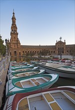 Spain, Seville, Boats floating on pond next to Plaza De Espana