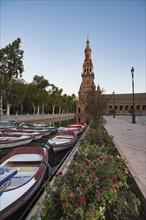 Spain, Andalusia, Seville, Rowboats moored in canal on Plaza de Espana at dawn