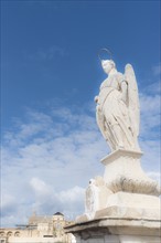 Spain, Andalusia, Cordoba, Statue of San Rafael against clouds