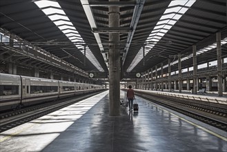 Spain, Andalusia, Cordoba, Woman on empty train platform