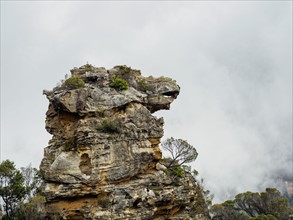 Australia, New South Wales, Katoomba, Large rock and cloudy sky behind