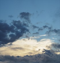 Blue sky with storm clouds at sunset