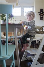 Boy at table on step ladder