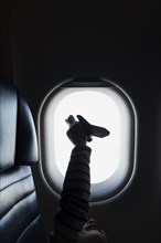 Silhouette of girl holding to airplane on airplane