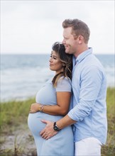 Pregnant couple embracing