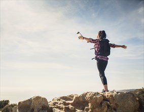Woman on hike with arms outstretched