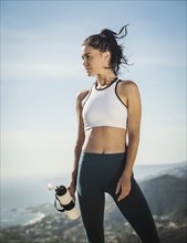 Woman in sportswear with water bottle