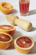 Sliced grapefruit with juicer