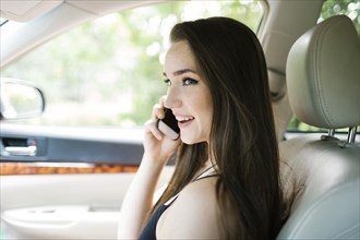 Young woman on phone in car