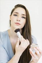 Woman applying make up with brush