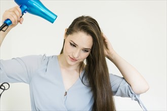 Woman using hair dryer