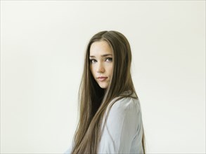 Portrait of young woman with long brown hair