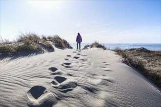 Woman walking on sand