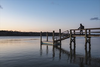 Silhouette of man on pier