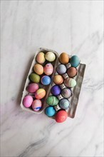 Dyed eggs in carton