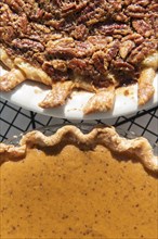 Pumpkin and pecan pies on a cooling rack