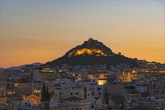 Cityscape at sunrise with Mount Lycabettus in Athens, Greece