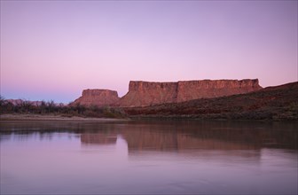 Cliffs by Colorado River at sunset in Utah, USA