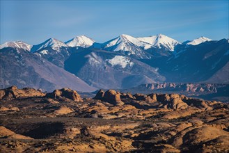 Snowcapped La Sal Mountains and sand dunes in Arches National Park, Utah, USA