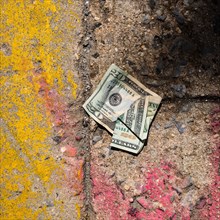 Crumpled money on sidewalk