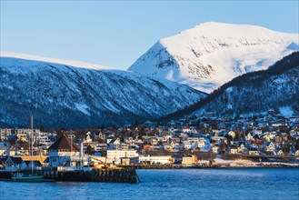 Town under snow covered mountains in Tromso, Norway