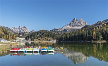 Colorful pedal boats moored on Lake Misurina in the Dolomites, South Tyrol, Italy