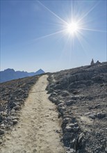 Sun over path in the Dolomites, South Tyrol, Italy