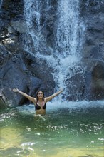 Woman by waterfall in Phuket, Thailand