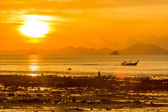 Silhouette of boat at sunset in West Railay, Thailand