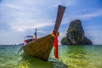 Boat by rock island in West Railay, Thailand