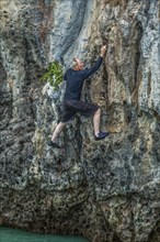 Man rock climbing in Phuket, Thailand