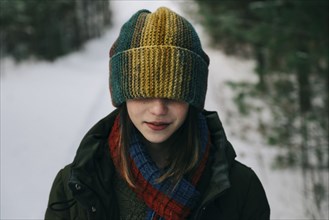 Teenage girl with colorful woollen hat during winter